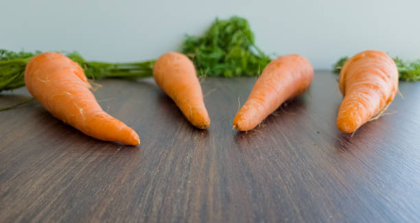 istock organic carrots on wooden table 1403261347