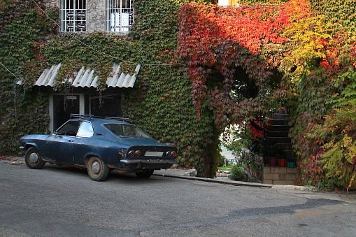 Douma, Lebanon, November 21, 2015: An old car parked in front of a house in Douma, Lebanon.