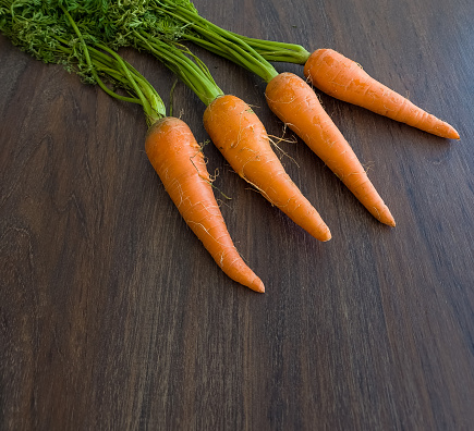 organic carrots on wooden table
