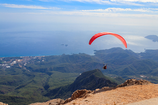 Paragliders flying from a top of Tahtali mountain near Kemer, Antalya Province in Turkey. Concept of active lifestyle and extreme sport adventure