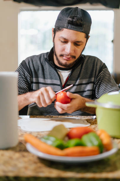 istock Household preparing lunch while a man cuts the vegetables 1403262759