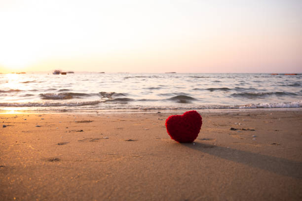 istock Heart shape on sand beach at coast 1403263856