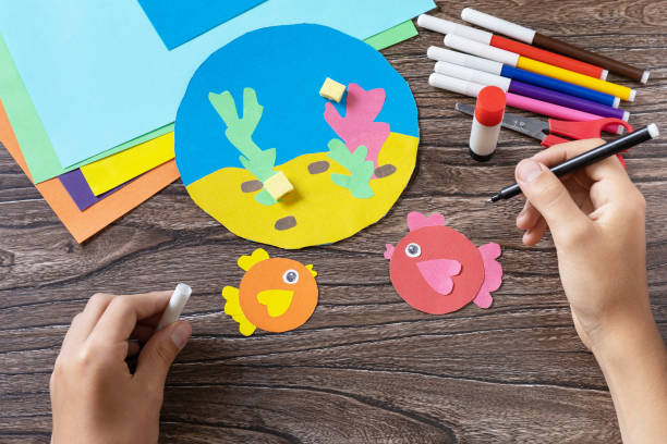 istock Instructions step 7. Summer card sea with volume fish. Handmade. Childrens creativity project, crafts for kids. 1403266079