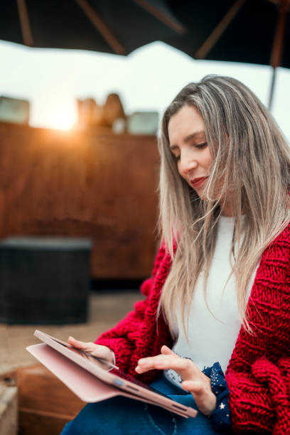 beautiful latin woman working outdoors with a tablet