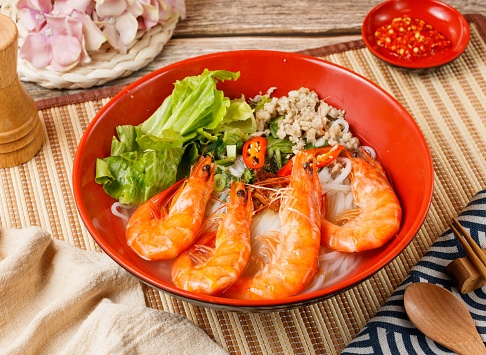 Fresh Shrimp Pho in a bowl isolated on mat side view on wooden table taiwan food