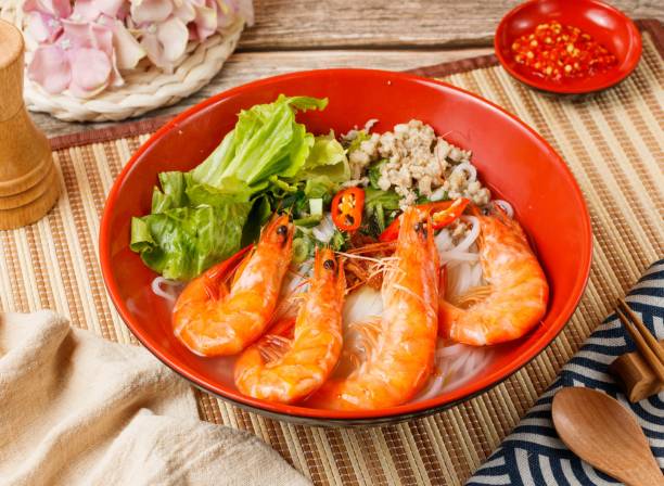 Fresh Shrimp Pho in a bowl isolated on mat side view on wooden table taiwan food stock photo