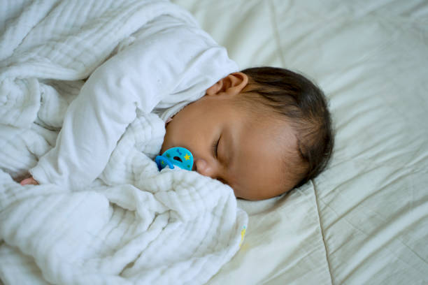 istock Daughter is sleeping alone close to her mother. 1403266850