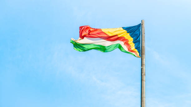 istock Colorful Seychelles flag waving against clean blue sky 1403267555