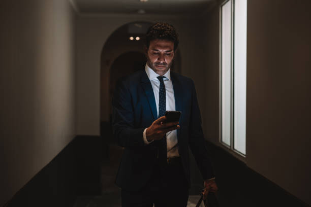 istock Businessman texting on mobile and walking to his hotel room 1403268088
