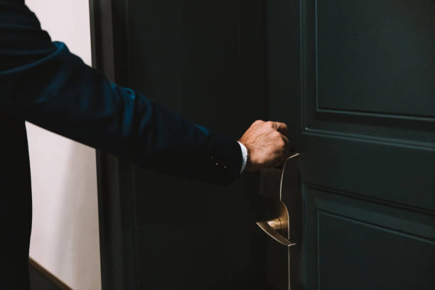 istock Elegant man entering a hotel room using a cardkey 1403269567