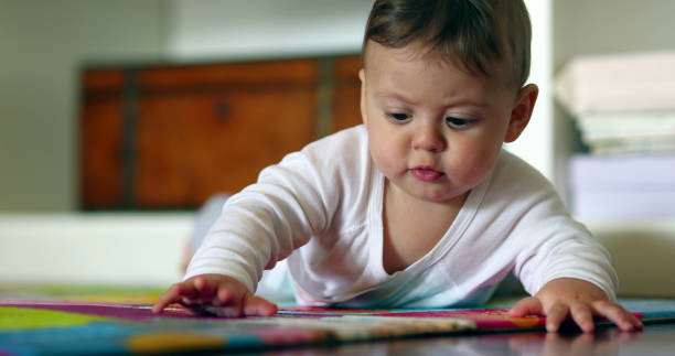 istock Adorable baby infant lying on floor 1403270407