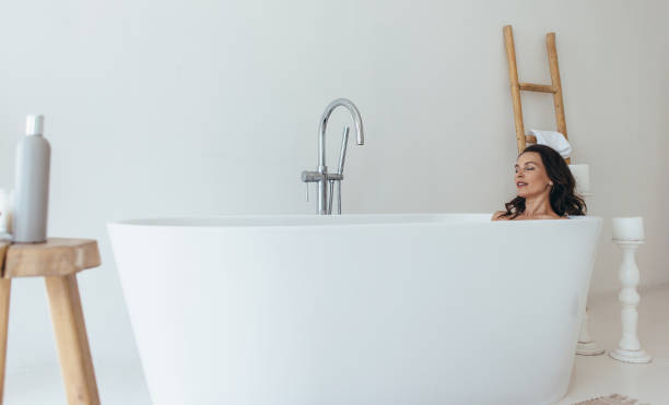 istock Woman resting in bathtub with eyes closed 1403271908