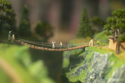 Model of mountainous area. Toy bridge in miniature. Tild shift shooting. Toy world.
