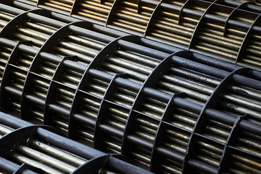 Heat exchangers tube bundle detail of industrial heat exchanger shell and tube condenser made of steel with corrosion. Abstract industrial background of carbon steel heat exchanger tube bundles.