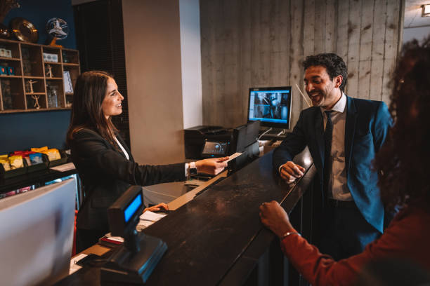 istock Business people checking-in at hotel reception desk 1403273465