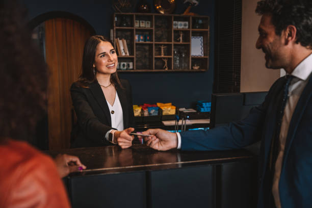 istock Business people checking-in at hotel reception desk 1403273872