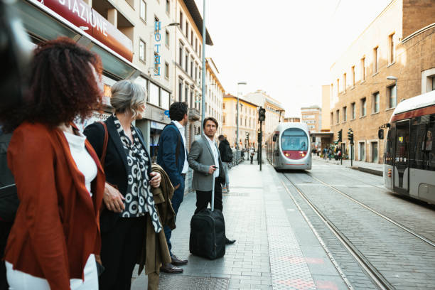 Business people waiting at bus stop for transportation to the hotel stock photo