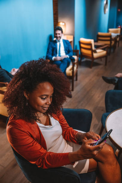 istock Woman texting on mobile sitting in a bar 1403275399