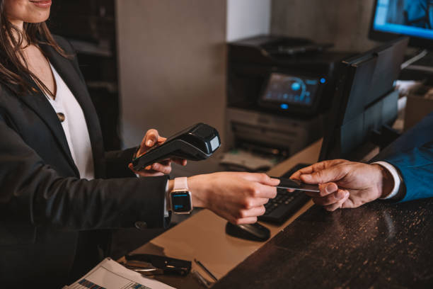 istock Man paying for his stay at hotel reception desk 1403275433