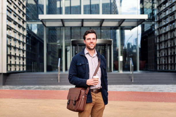 istock smiling business man in front of office building 1403276879