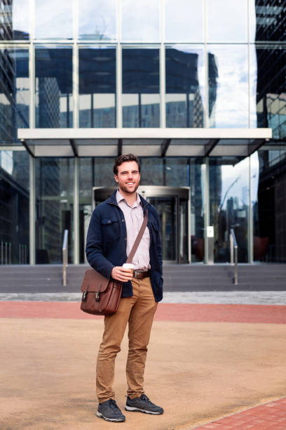 istock smiling business man in front of office building 1403276885