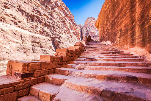Petra, Jordan - Ancient capital of the Nabatean kingdom, present Wadi Musa city in Jordanian Kingdom. Rocky steps to view point over Treasury.