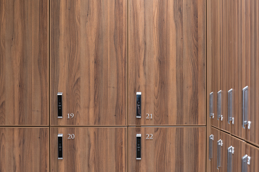 Many wooden lockers with numbers on doors