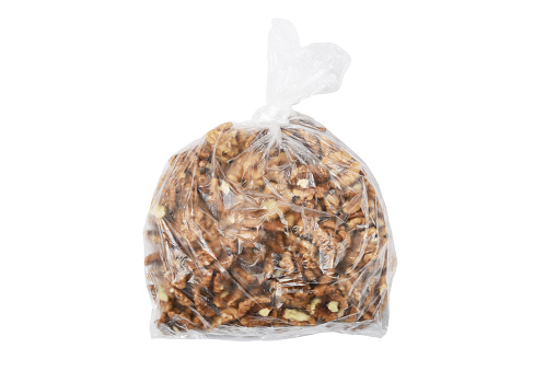 Peeled walnuts in the transparent plastic bag isolated on the white background with clipping path