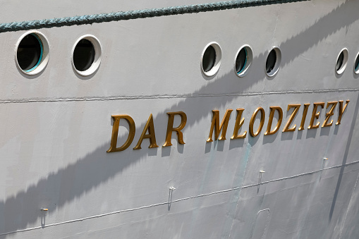 Gdynia, Poland - May 27, 2022: Dar Mlodziezy , lettering on the side of the ship. This is the name of a three-masted Polish training sailing ship, frigate type built in the Gdansk Shipyard in 1982