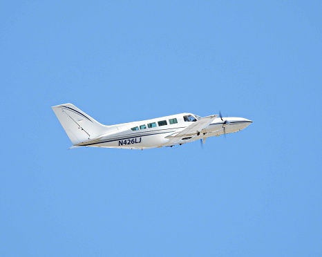 Single engine plane (Aronca 7AC) flying through the Lost River Mountains of East Central Idaho.