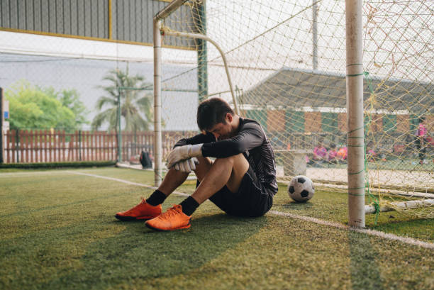 Mid adult male footballer dribbling around opponent A soccer player dribbles down the field and makes a goal and the team celebrates athlete fails stock pictures, royalty-free photos & images