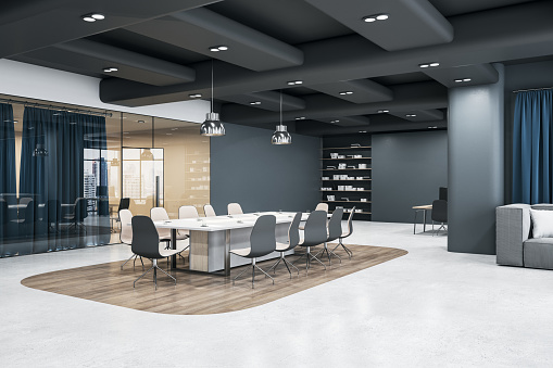 Modern interior design office with stylish white conference table surrounded by beige chairs on wooden island among light concrete floor, glass door grey walls and ceiling. 3D rendering