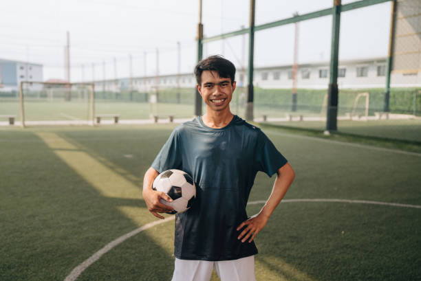istock Portrait : Young man playing a game of soccer 1403282414