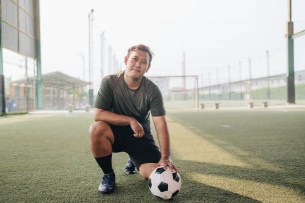 istock Portrait : Young man playing a game of soccer 1403282579