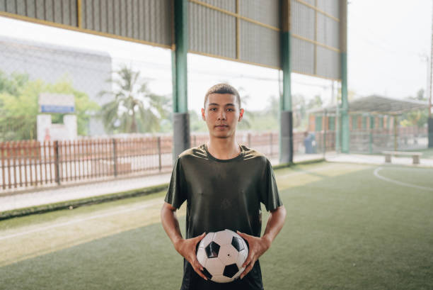 istock Portrait : Young man playing a game of soccer 1403283570