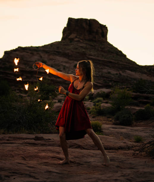istock Young woman dancing with fire 1403287560