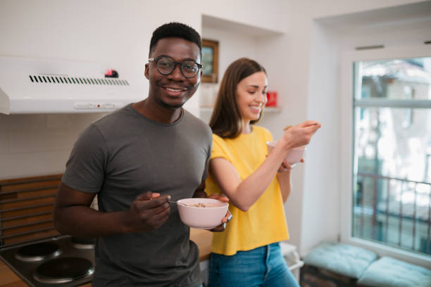 istock Happy roommates enjoying breakfast at home 1403288390
