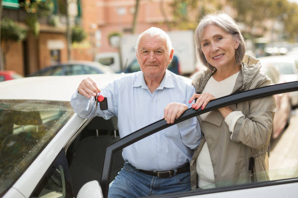 istock Senior couple standing beside car 1403289894