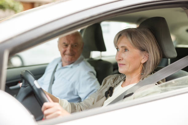 istock Old man and woman sitting in car 1403289901