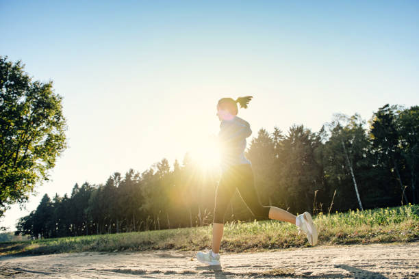 istock view on woman running on country path 1403293540