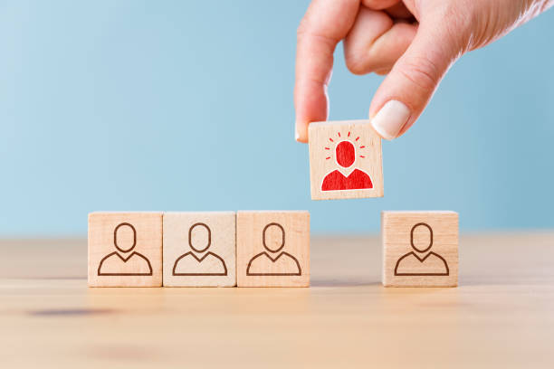 istock Person icon on wooden cube with hand picked different from the crowd 1403293578