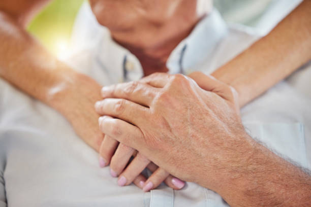 istock Closeup doctor holding hands on patients chest showing support during recovery. Unrecognizable health care worker demonstrating chest cpr in case of emergency heart attack, teaching chest compressions 1403293735