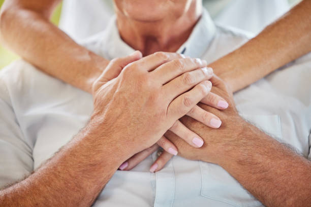 istock Closeup doctor holding hands on patients chest showing support during recovery. Unrecognizable health care worker demonstrating chest cpr in case of emergency heart attack, teaching chest compressions 1403294569