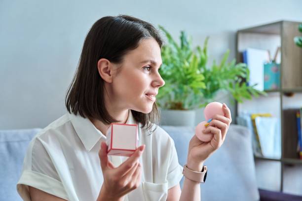 istock Young beautiful woman with cosmetic perfumed soap in her hands 1403294679