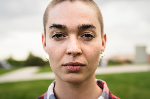 Shaved head girl looking at camera portrait
