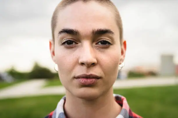 Photo of Shaved head girl looking at camera portrait