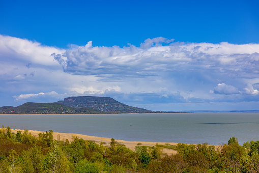 Scenic view of mountain and lake against cloudy sky from lookout hill in forest. Balaton
