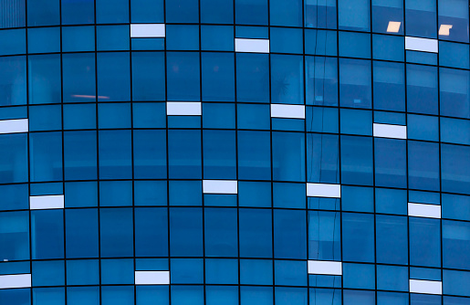 Abstract exterior architecture facade of  modern glass windows residential  building in Abu Dhabi