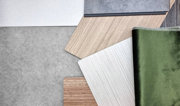 istock close up, combination of interior material samples containg green velvet fabric, white fabric laminateds, oak wood veneers and concrete vinyl flooring. interior mood and tone board for presentation. 1403300014