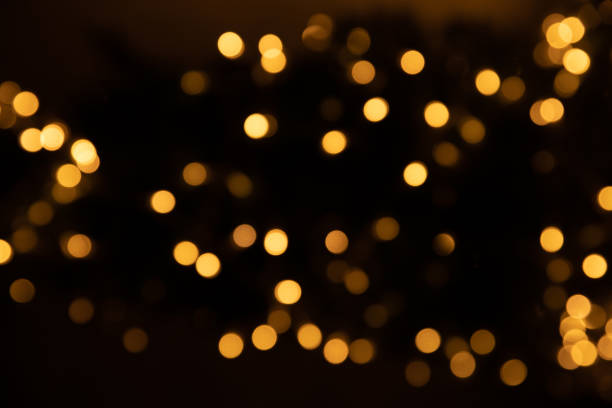 istock Golden bokeh on a black background.Postcard. Place for text.Lights.Blurred background.Banner 1403301091